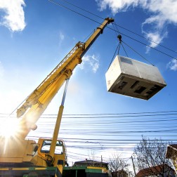 Mobile crane operating by lifting and moving electric generator